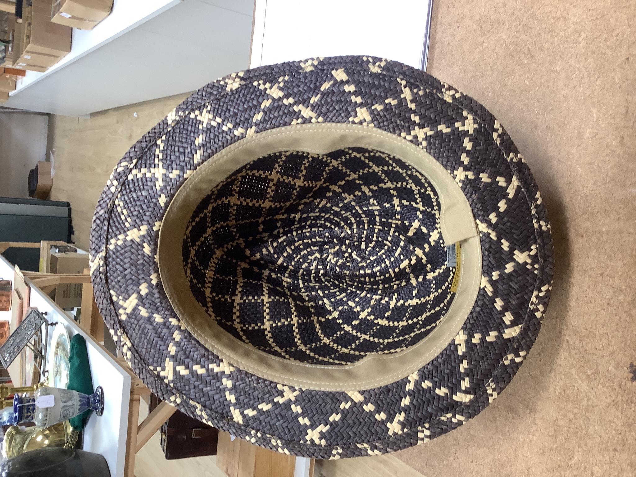 A Moroccan Fez and a Panama hat in a Dunn & Co hat box together with a hat stand